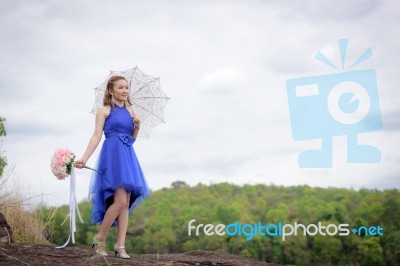 Beautiful Woman Wear Blue Evening Dress Hold A Bouquet Of Flower… Stock Photo