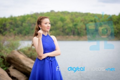 Beautiful Woman Wear Blue Evening Dress Over Mountains And River… Stock Photo