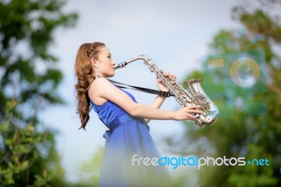 Beautiful Woman Wear Blue Evening Dress Sound Saxophone Over Mou… Stock Photo