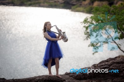 Beautiful Woman Wear Blue Evening Dress Sound Saxophone Stand On… Stock Photo