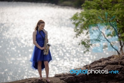 Beautiful Woman Wear Blue Evening Dress Sound Saxophone Stand On… Stock Photo