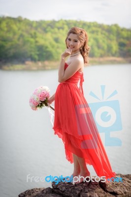 Beautiful Woman Wear Red Evening Dress Hold A Bouquet Of Flowers… Stock Photo