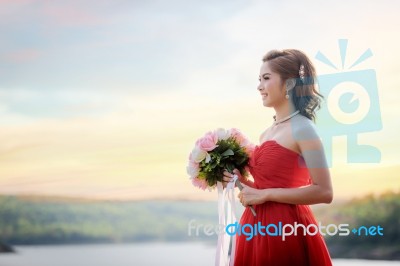 Beautiful Woman Wear Red Evening Dress Hold A Bouquet Of Flowers… Stock Photo