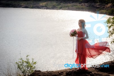 Beautiful Woman Wear Red Evening Dress Hold A Bouquet Of Flowers… Stock Photo