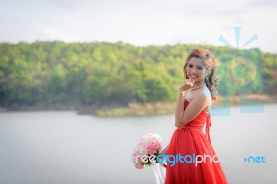 Beautiful Woman Wear Red Evening Dress Hold A Bouquet Of Flowers… Stock Photo