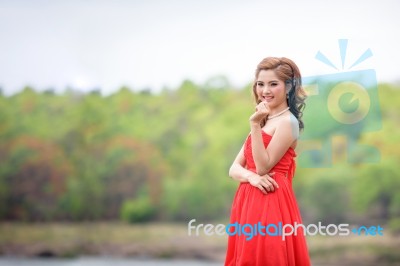 Beautiful Woman Wear Red Evening Dress Over Mountains And Rivers… Stock Photo