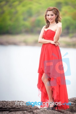 Beautiful Woman Wear Red Evening Dress Over Mountains And Rivers… Stock Photo