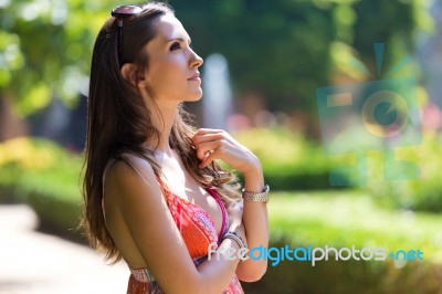 Beautiful Woman With Dark Hair And Brown Eyes Posing At Summer G… Stock Photo