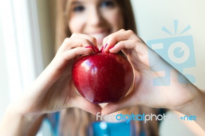 Beautiful Woman With Red Apple At Home Stock Photo