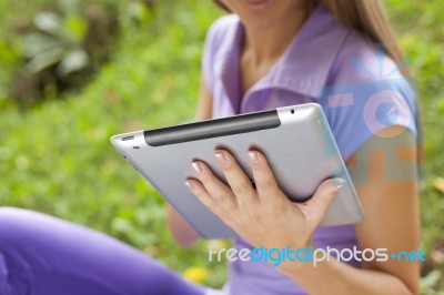 Beautiful Woman With Tablet Computer In Park Stock Photo