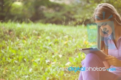 Beautiful Woman With Tablet Computer In Park Stock Photo