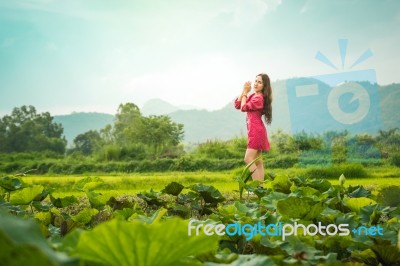 Beautiful Young Attractive  Asian Women In Red Dress On Sunrise Beautiful Nature Background Of The Mountains And Lotus Garden Image Of Happy  Camping, Travel, Lifestyle Resting , Relaxing Concept Vintage Style Stock Photo