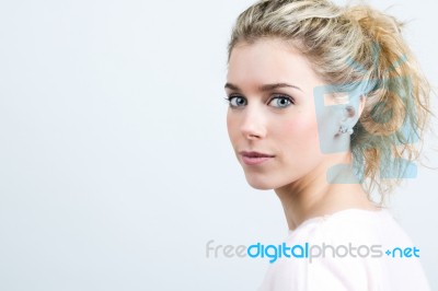 Beautiful Young Blonde Woman Looking At The Camera Stock Photo