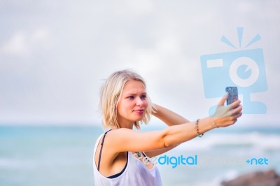 Beautiful Young Blonde Woman Posing Outdoor At The Rocky Sea Sho… Stock Photo