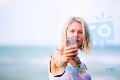 Beautiful Young Blonde Woman Posing Outdoor At The Rocky Sea Sho… Stock Photo