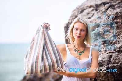 Beautiful Young Blonde Woman Posing Outdoor At The Rocky Sea Sho… Stock Photo