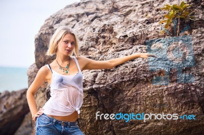 Beautiful Young Blonde Woman Posing Outdoor At The Rocky Sea Sho… Stock Photo