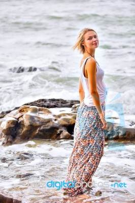 Beautiful Young Blonde Woman Posing Outdoor At The Rocky Sea Sho… Stock Photo