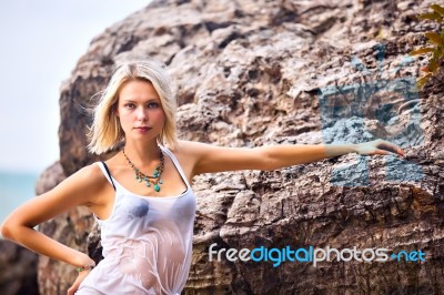 Beautiful Young Blonde Woman Posing Outdoor At The Rocky Sea Sho… Stock Photo