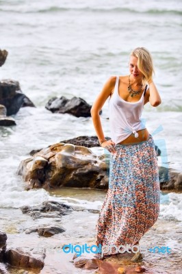 Beautiful Young Blonde Woman Posing Outdoor At The Rocky Sea Sho… Stock Photo