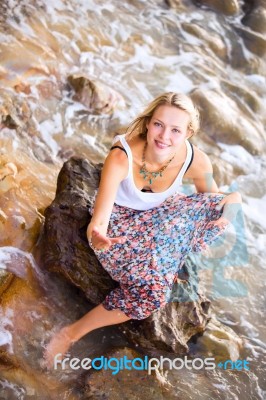 Beautiful Young Blonde Woman Posing Outdoor At The Rocky Sea Sho… Stock Photo