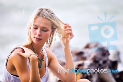 Beautiful Young Blonde Woman Posing Outdoor At The Rocky Sea Sho… Stock Photo