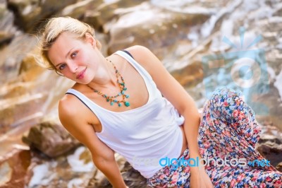 Beautiful Young Blonde Woman Posing Outdoor At The Rocky Sea Sho… Stock Photo