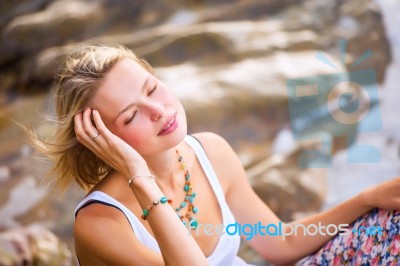 Beautiful Young Blonde Woman Posing Outdoor At The Rocky Sea Sho… Stock Photo