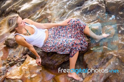 Beautiful Young Blonde Woman Posing Outdoor At The Rocky Sea Sho… Stock Photo