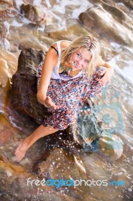 Beautiful Young Blonde Woman Posing Outdoor At The Rocky Sea Sho… Stock Photo