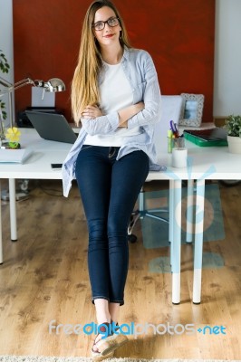 Beautiful Young Businesswoman Looking At Camera In The Office Stock Photo