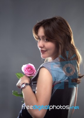 Beautiful Young Girl With A Pink Rose Stock Photo