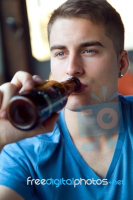 Beautiful Young Man Drinking Beer In The Bar Stock Photo