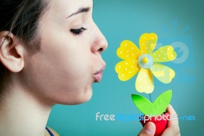 Beautiful Young Woman Blowing On Artificial Daisy Stock Photo
