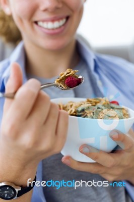 Beautiful Young Woman Eating Cereals At Home Stock Photo