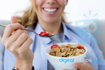 Beautiful Young Woman Eating Cereals At Home Stock Photo