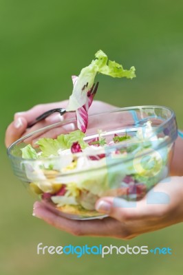 Beautiful Young Woman Holding Green Salad, Outdoors Stock Photo