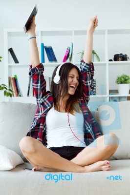 Beautiful Young Woman Listening To Music At Home Stock Photo