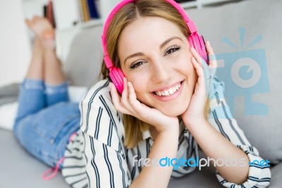 Beautiful Young Woman Listening To Music At Home Stock Photo