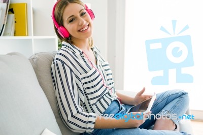 Beautiful Young Woman Listening To Music With Digital Tablet Stock Photo