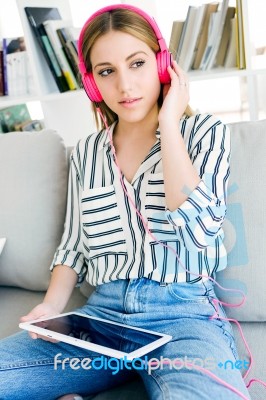 Beautiful Young Woman Listening To Music With Digital Tablet Stock Photo