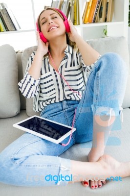 Beautiful Young Woman Listening To Music With Digital Tablet Stock Photo