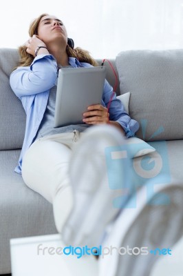 Beautiful Young Woman Listening To Music With Digital Tablet At Stock Photo