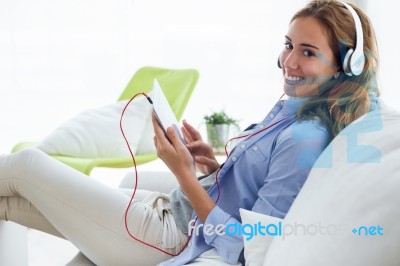 Beautiful Young Woman Listening To Music With Digital Tablet At Stock Photo