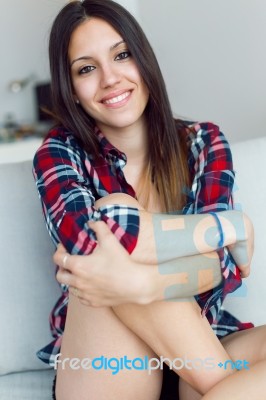 Beautiful Young Woman Looking At Camera At Home Stock Photo