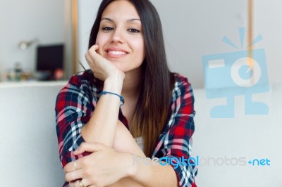 Beautiful Young Woman Looking At Camera At Home Stock Photo