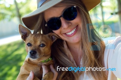 Beautiful Young Woman Looking At Camera With Her Dog Stock Photo