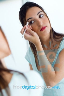 Beautiful Young Woman Making Make-up Near Mirror Stock Photo