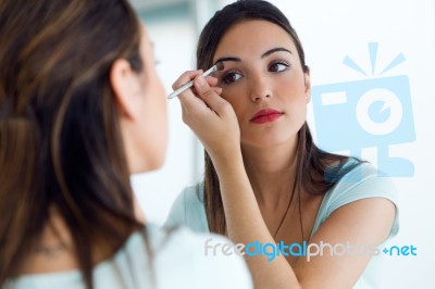 Beautiful Young Woman Making Make-up Near Mirror Stock Photo