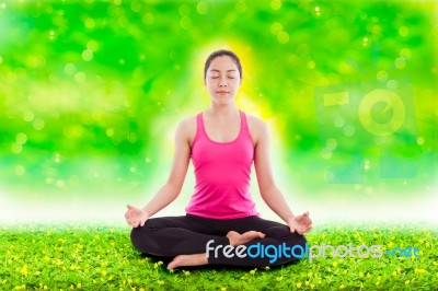 Beautiful Young Woman Practicing Yoga, Sitting In A Lotus Position Stock Photo